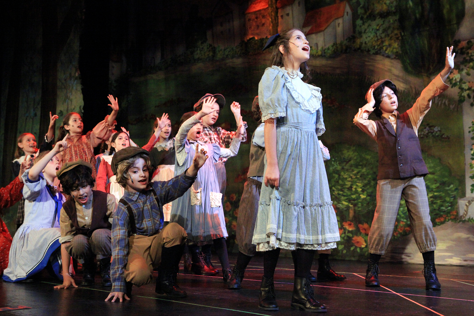 Cast members performing on stage.