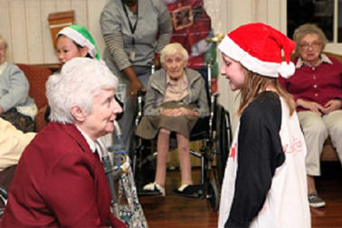 Kids interacting with the elderly at an event.
