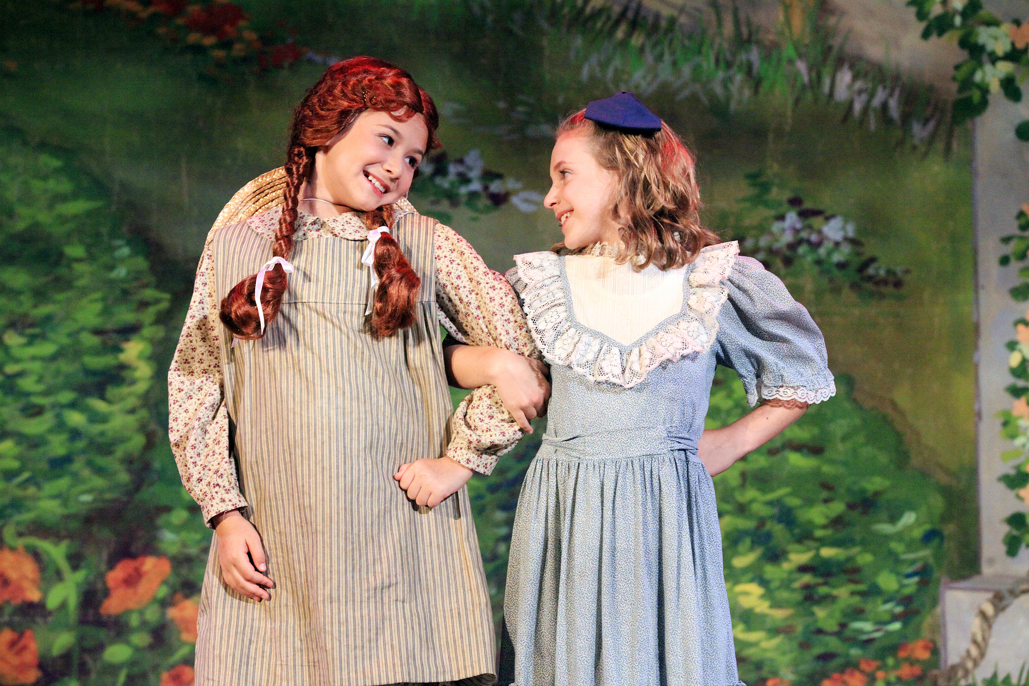 Actresses performing Anne of Green Gables on stage.