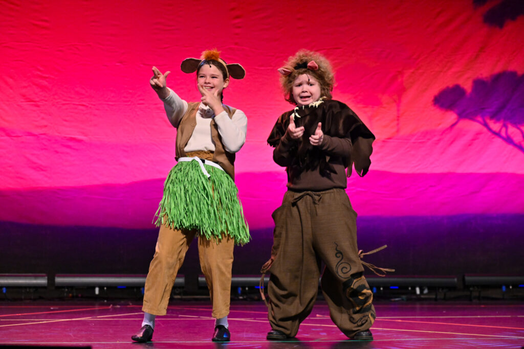 Cast members on stage performing in The Lion King